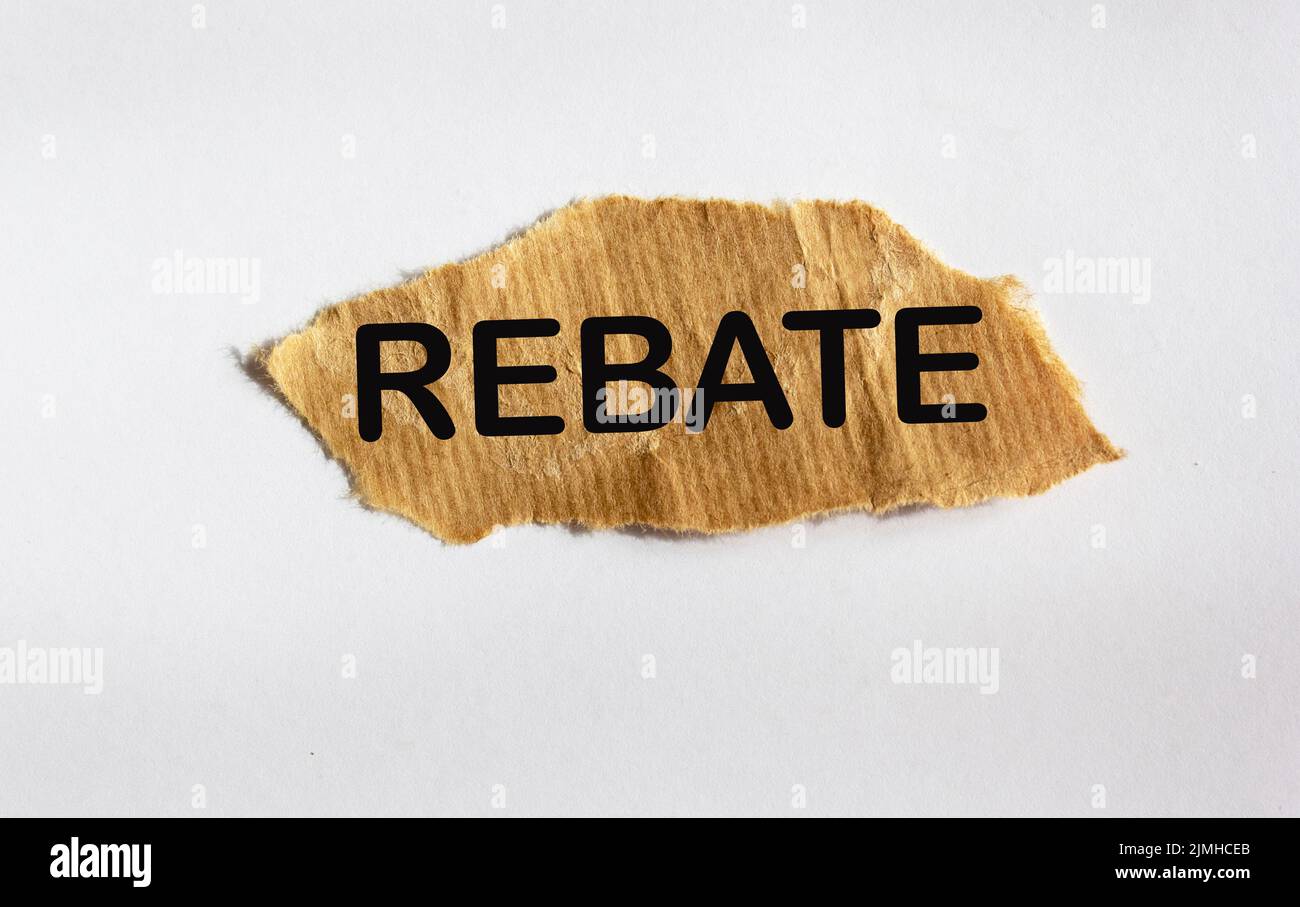 REBATE concept, on brown scrap paper and white background Stock Photo