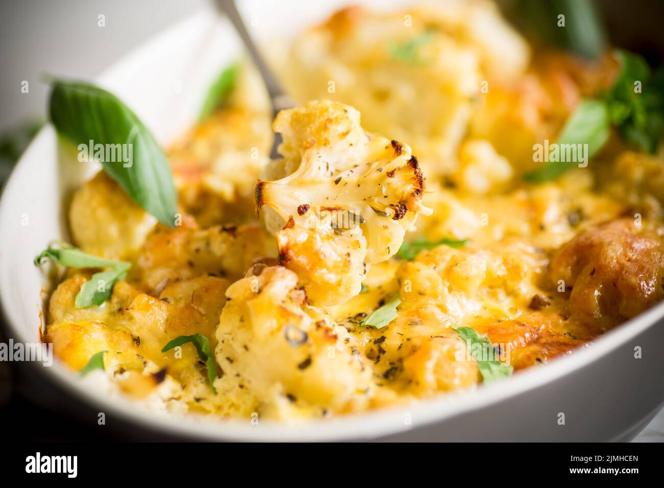 baked cauliflower with vegetables and cheese and scrambled eggs in a