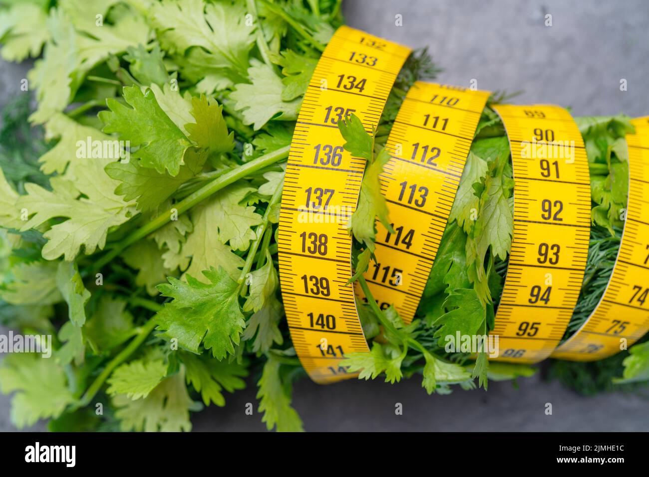 Measuring tape for measuring the circumference. Vegetables for diet cooking. Stock Photo