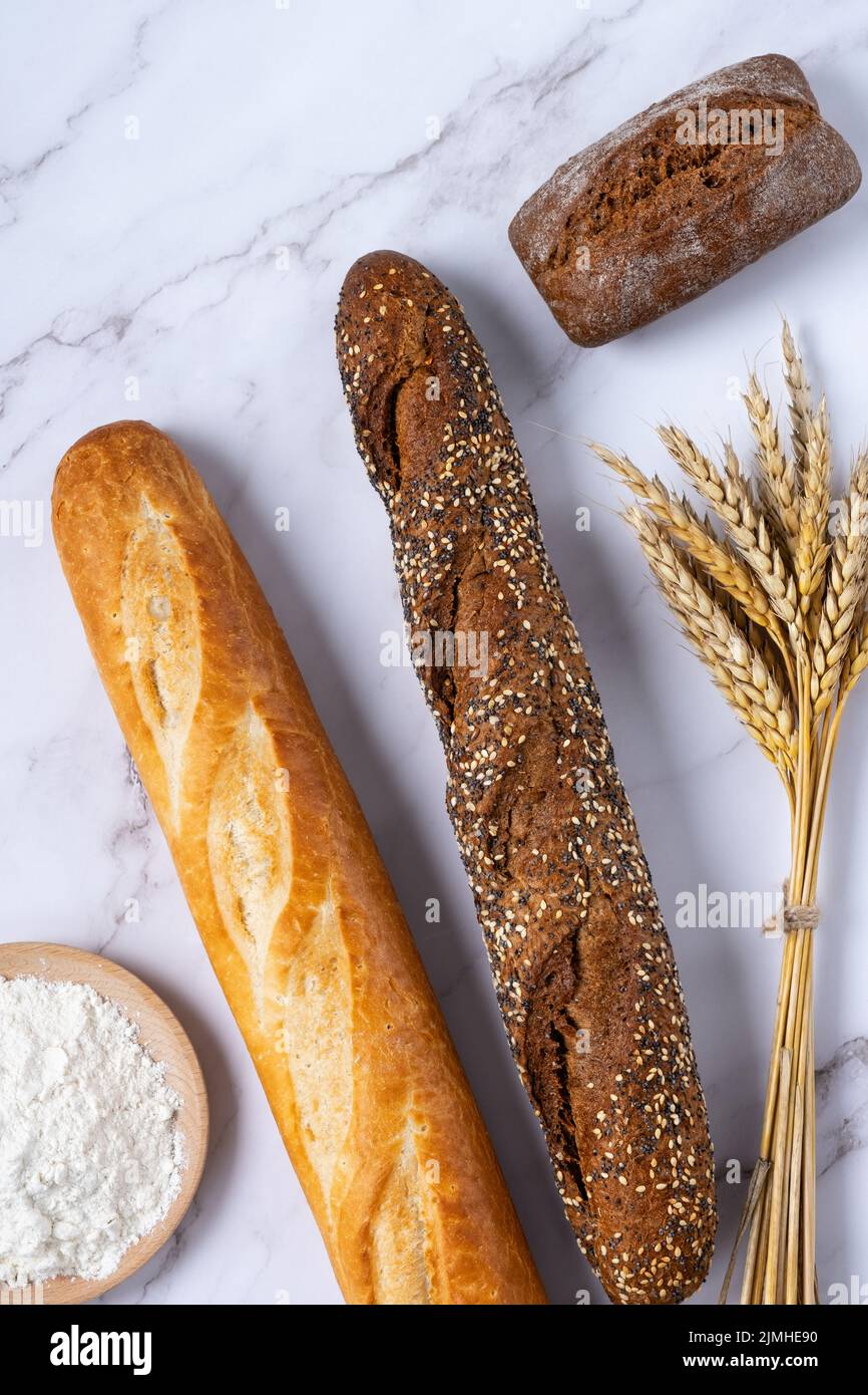 Bakery - various kinds of breadstuff. Bread rolls, baguette, croissant and flour Stock Photo