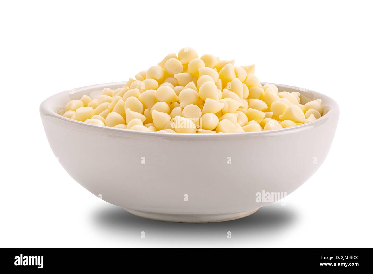 White chocolate chips in ceramic cup isolated on white background Stock