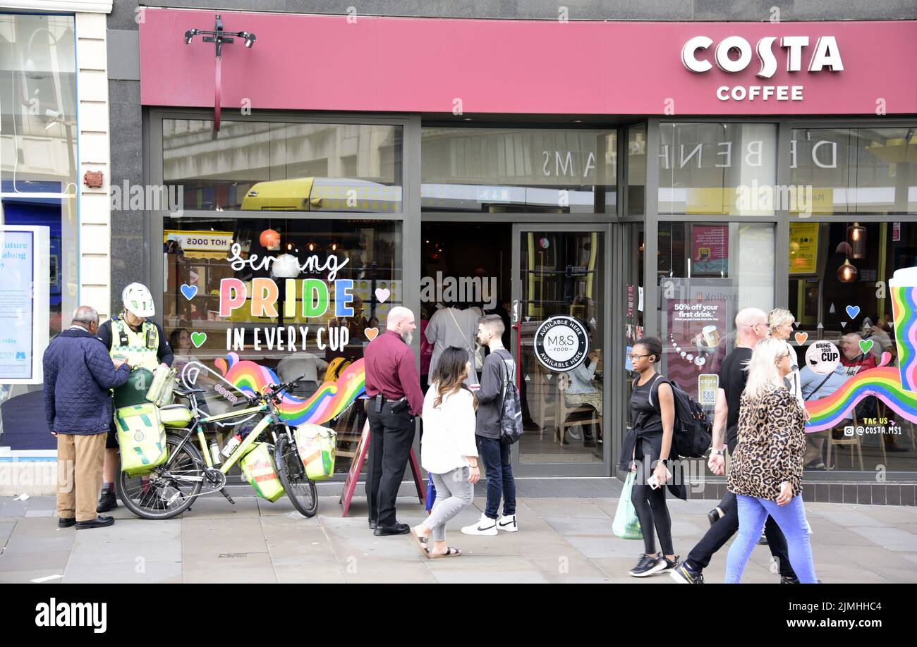 Manchester, UK, 6th August, 2022. Costa Coffee branch on Market Street, Manchester, England, United Kingdom, British Isles, with LGBT Pride supportive message in the window.  Passers by walk past. Credit: Terry Waller/Alamy Live News Stock Photo