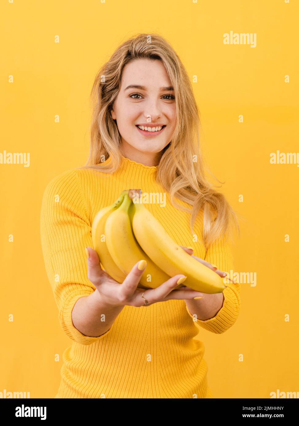 Front view woman holding bananas Stock Photo Alamy