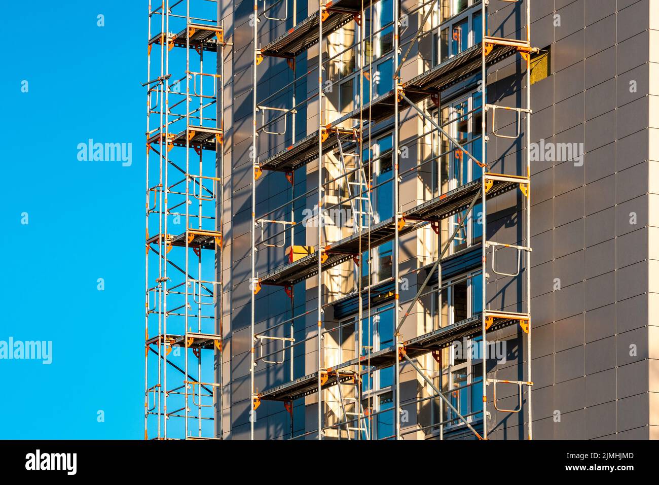 Scafolding on the exterior multistory house wall Stock Photo