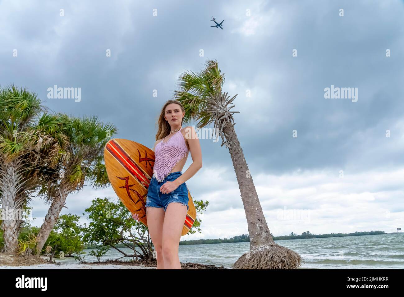 Lovely Blonde Model Enjoying A Summers Day While Preparing To Surf On The Ocean With Her Boogie Board Stock Photo