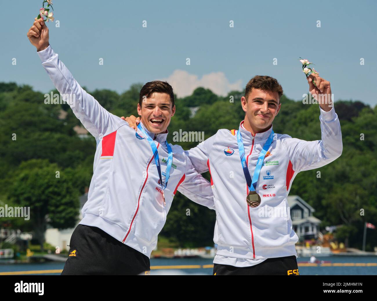 Dartmouth, Canada. August 6th, 2022. Gold Medalists and World Champions Pablo Martinez and Cayetano Garcia from Spain receiving their medal in the C2 Men 500m event. The 2022 ICF Canoe Sprint and Paracanoe World Championships takes place on Lake Banook in Dartmouth (Halifax). Credit: meanderingemu/Alamy Live News Stock Photo