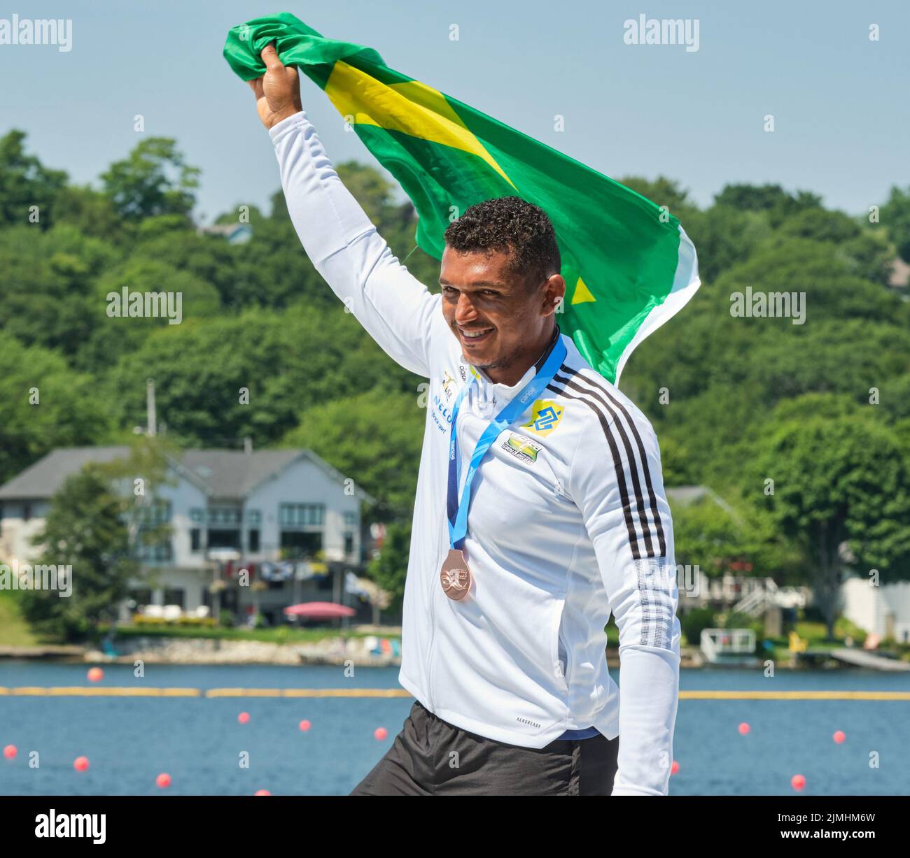 Dartmouth, Canada. August 6th, 2022. Gold Medalists and World Champion Isaquias dos Santos from Brazil celebrating during at his medal ceremony in the C1 Men 500m event. Santos had a dominating race finishing over 2 sconds ahead of the field The 2022 ICF Canoe Sprint and Paracanoe World Championships takes place on Lake Banook in Dartmouth (Halifax). Credit: meanderingemu/Alamy Live News Stock Photo