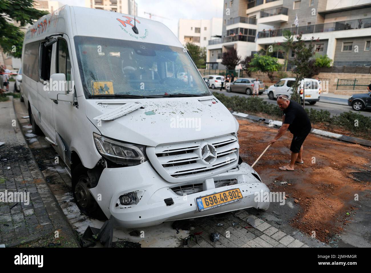 (220806) -- ASHKELON (ISRAEL), Aug. 6, 2022 (Xinhua) -- A man clears an area hit by a rocket fired from Gaza in the southern Israeli city of Ashkelon, on Aug. 6, 2022. The Israeli military continued on Saturday its military operation against the Palestinian Islamic Jihad (PIJ), bombing dozens of targets belonging to the militant group in the Gaza Strip, while hundreds of rockets were launched from the Palestinian enclave toward Israel. (Ilan Assayag/JINI via Xinhua) Stock Photo