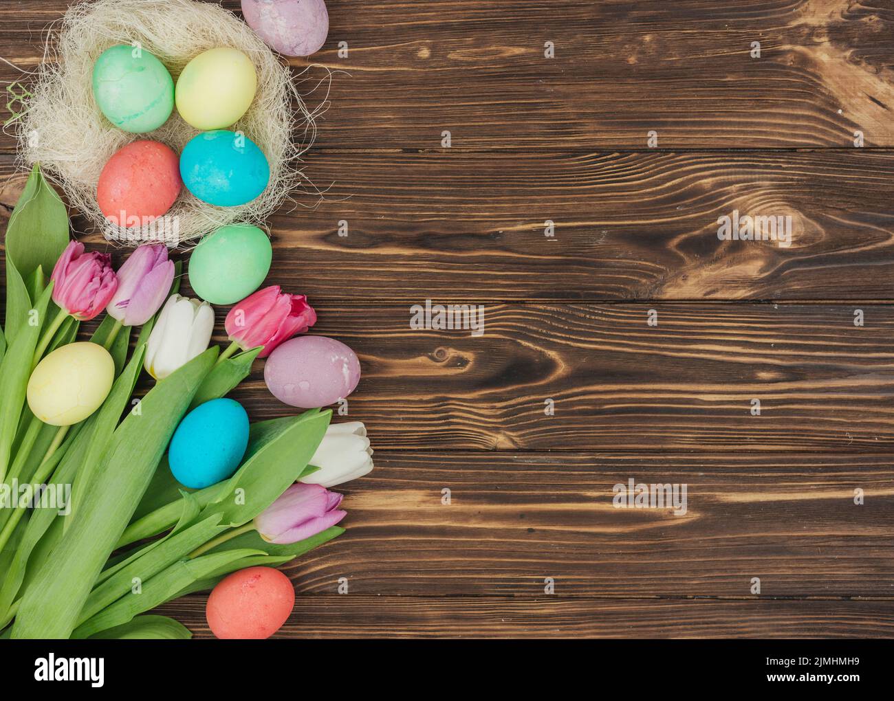 Easter eggs nest with tulips table Stock Photo