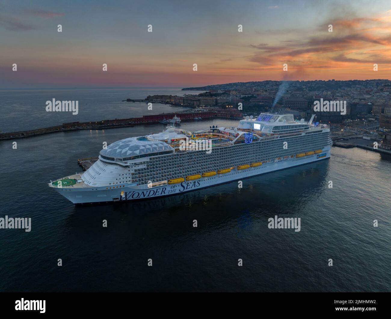 Wonder of the Seas by Royal Caribbean is The biggest cruise ship in the world in Naples port.. Aerial view Stock Photo