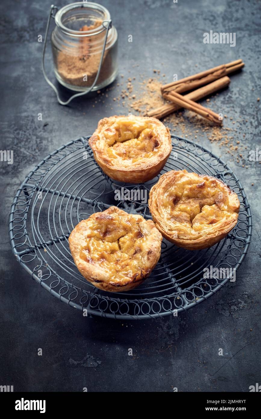 Traditional Portuguese pasteis de nata as closeup on a cooling rack