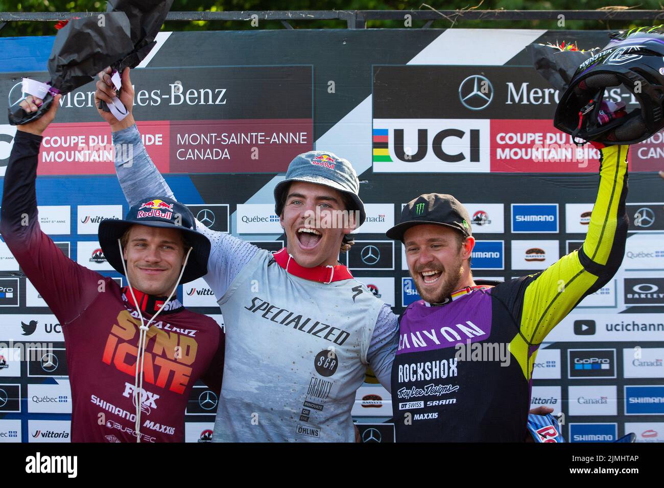 August 06, 2022: Finn Iles of Canada (3) (center) wins the World Cup MenÕs Downhill Final and celebrates with Laurie Greenland of Great Britain (left) and Troy Brosnan of Australia (right) during the 2022 Mercedes-Benz UCI Mountain Bike World Cup held at Mont-Sainte-Anne in Beaupre, Quebec, Canada. Daniel Lea/CSM Stock Photo