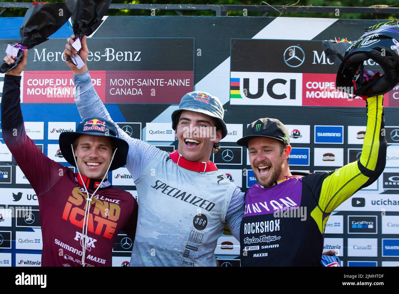 August 06, 2022: Finn Iles of Canada (3) (center) wins the World Cup MenÕs Downhill Final and celebrates with Laurie Greenland of Great Britain (left) and Troy Brosnan of Australia (right) during the 2022 Mercedes-Benz UCI Mountain Bike World Cup held at Mont-Sainte-Anne in Beaupre, Quebec, Canada. Daniel Lea/CSM Stock Photo