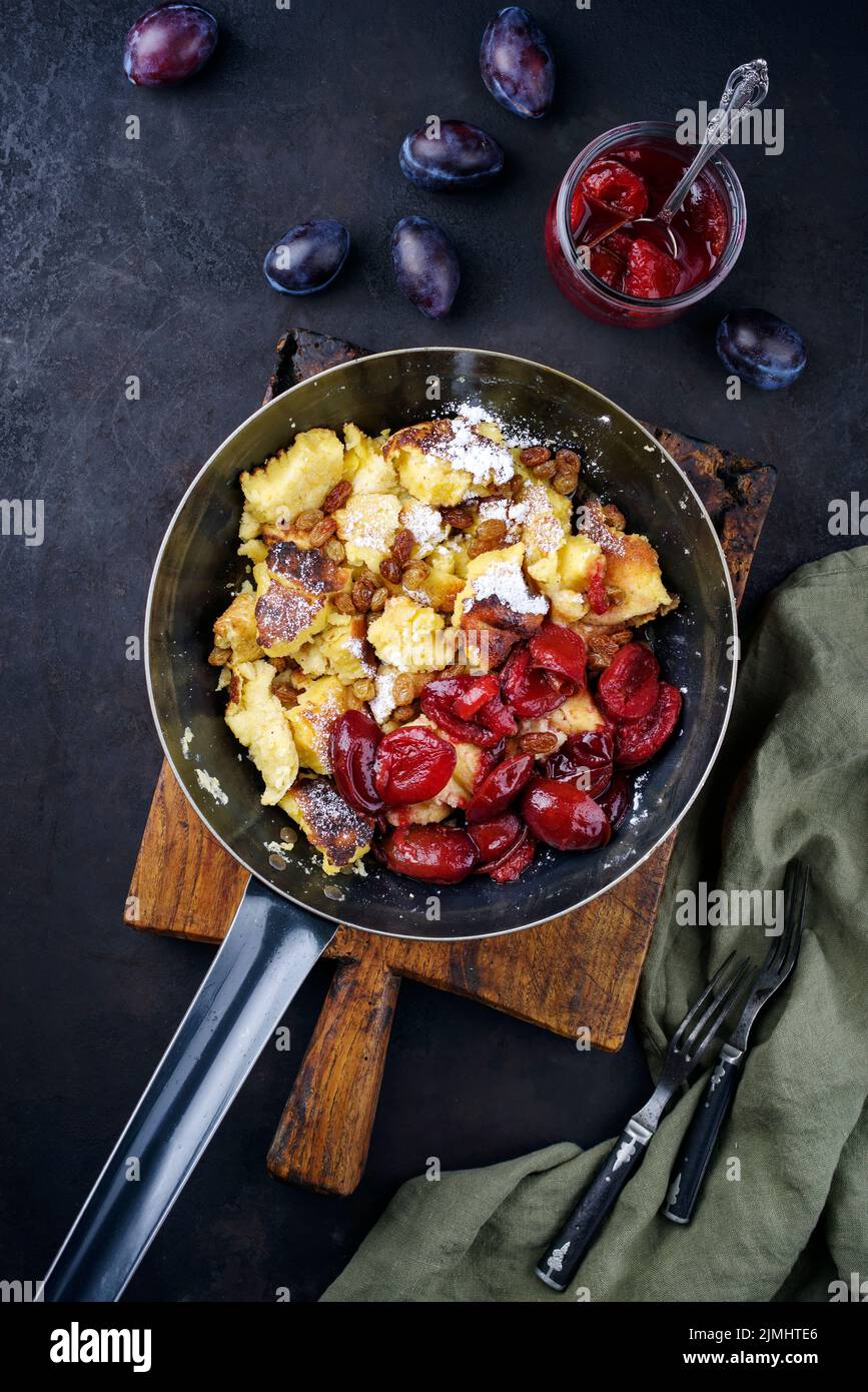 Traditional Austrian Kaiserschmarren with plums and raisins served as a ...