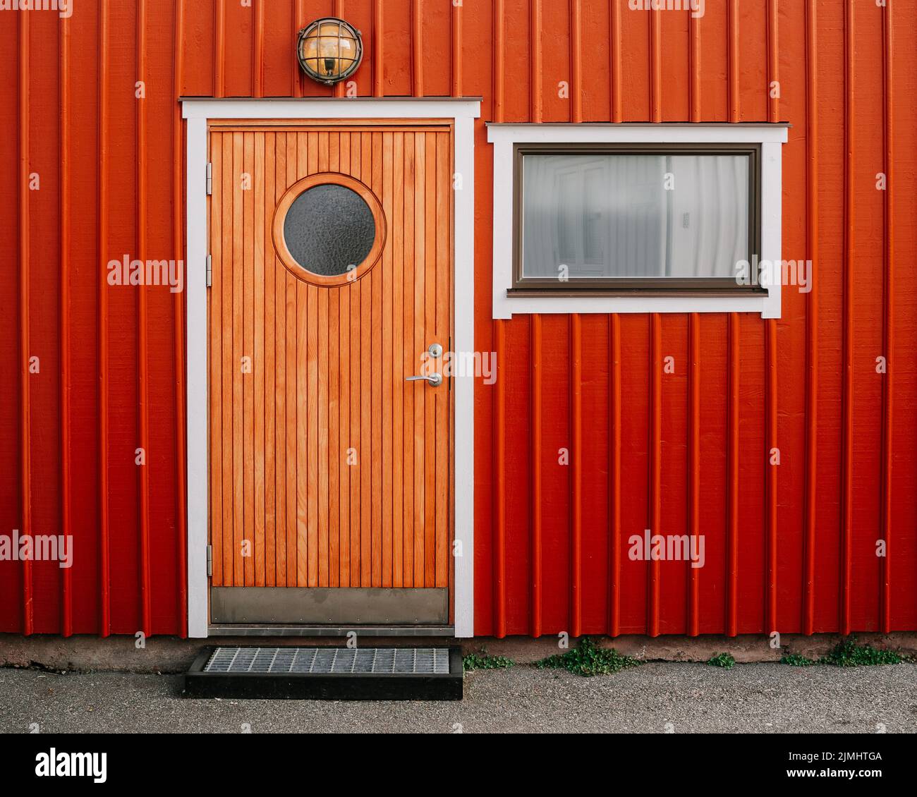 A typical Swedish cottage facade painted in the 'Falun copper red' color Stock Photo