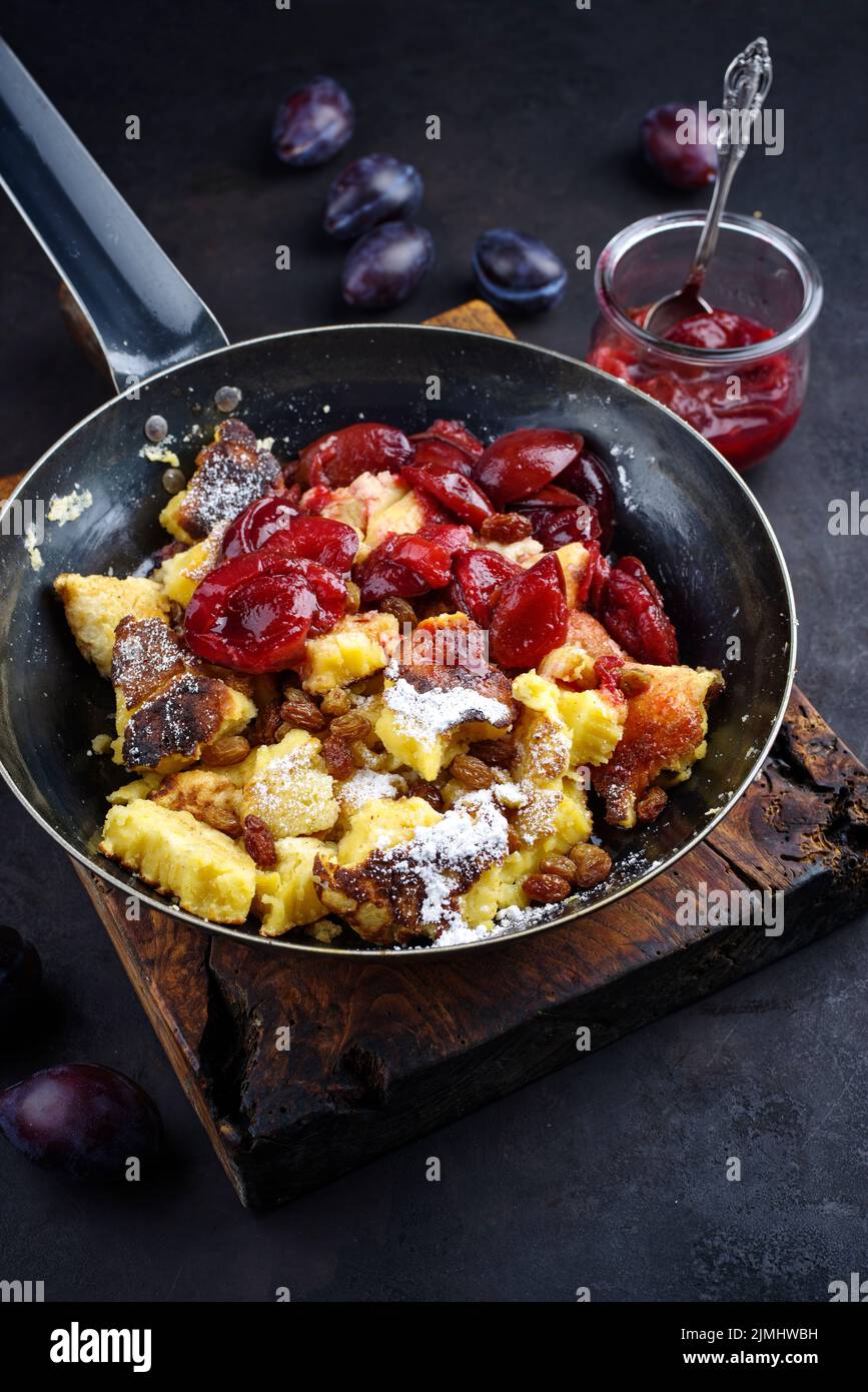 Traditional Austrian Kaiserschmarren with plums and raisins served as ... Traditional Austrian Kaiserschmarren with plums and raisins served as ...