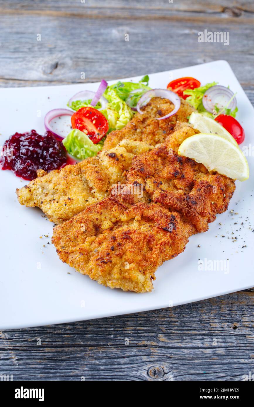 Traditional deepfried schnitzel with green salad Stock Photo Alamy