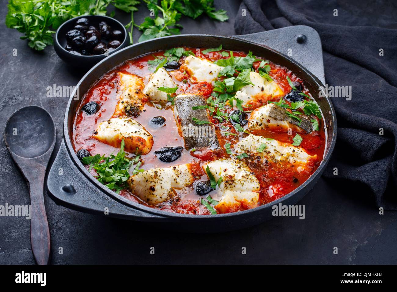 Traditional Spanish seafood zarzuela de pescado with fish served in red ...