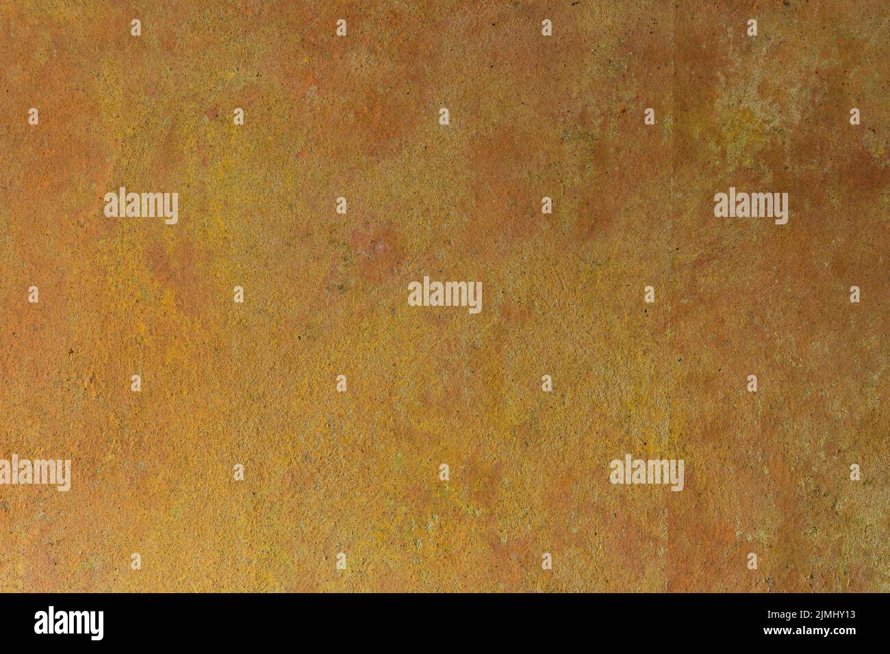 The yellow-orange texture of the aged concrete wall of an old house. Decorative textured plaster, inside surface finish at home. Abstract background with construction concept. Stock Photo