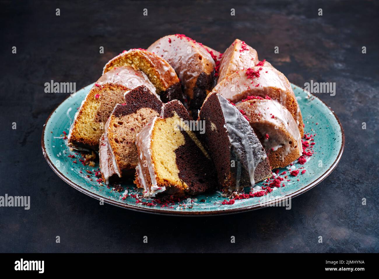 Traditional exotically bundt marble cocoa chocolate cake with icing sugar glaze and freeze dry
