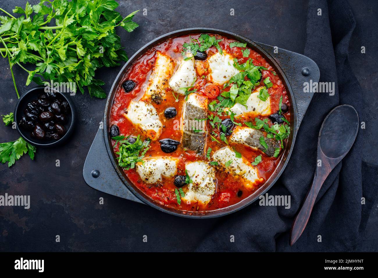 Traditional Spanish seafood zarzuela de pescado with fish served in red ...
