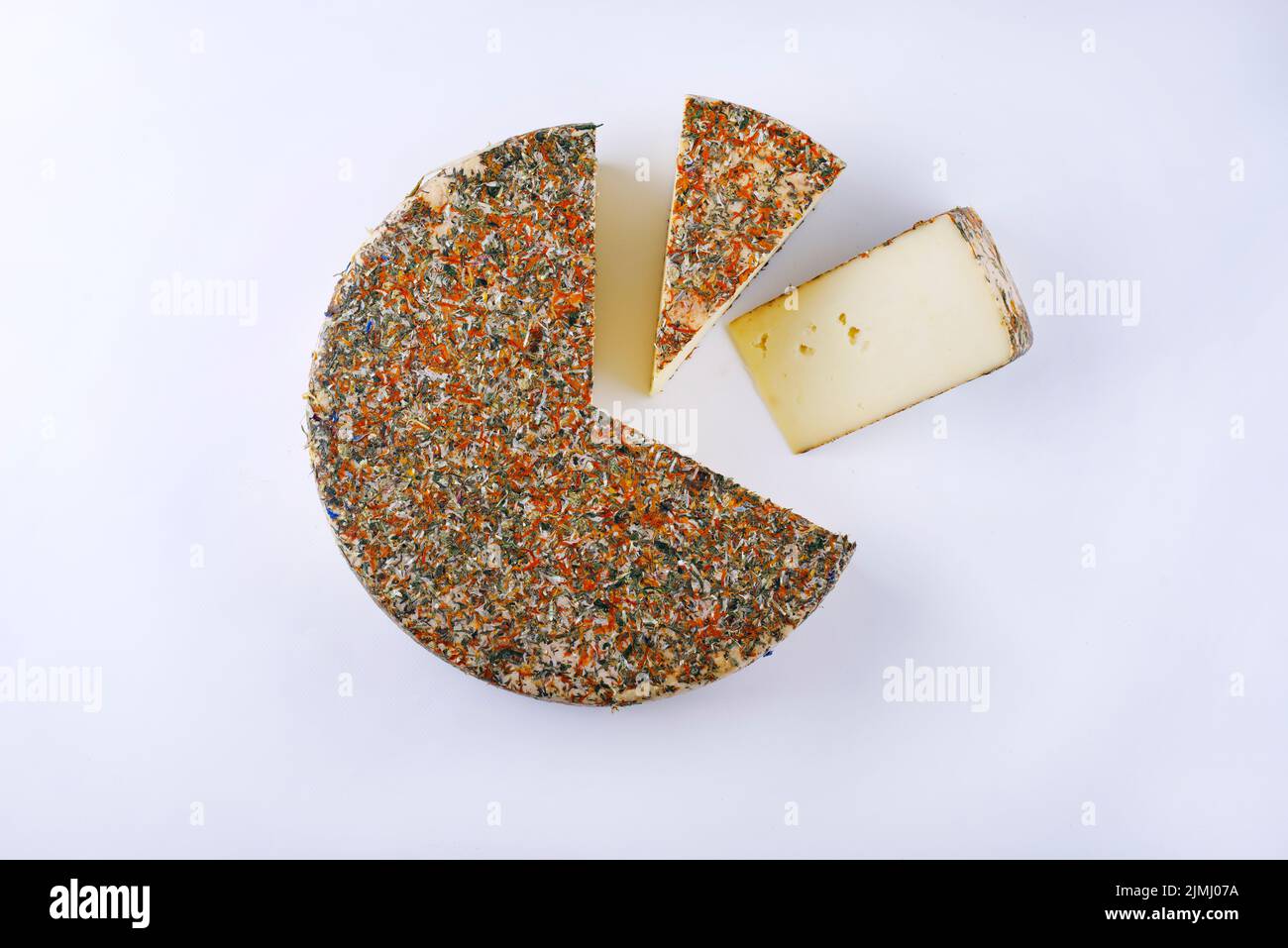 Traditional aged hay flower mountain cheese loaf of the Alps offered as