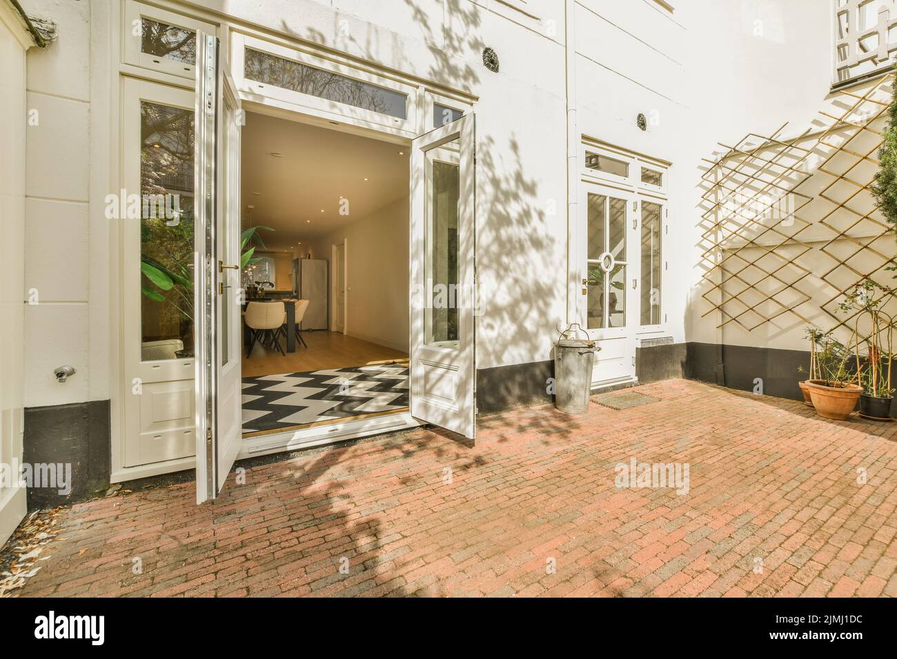 Fancy lamp hanging on ceiling over stylish furniture in spacious living