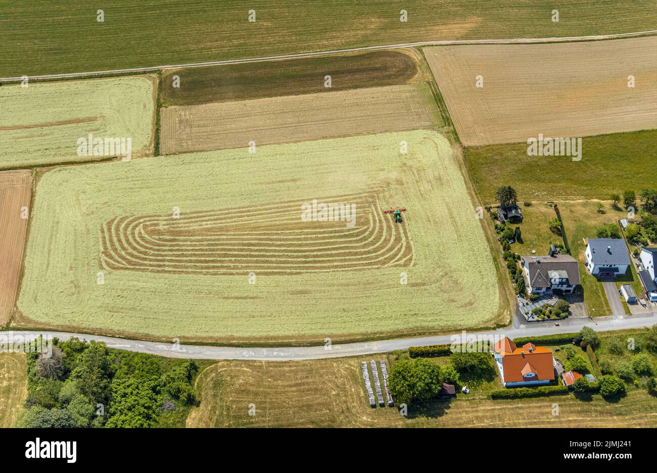 Aerial view, agricultural fields, haymaking, tractor mowing meadow, Liboriweg, Balve, Sauerland, North Rhine-Westphalia, Germany, DE, Europe, shapes a Stock Photo