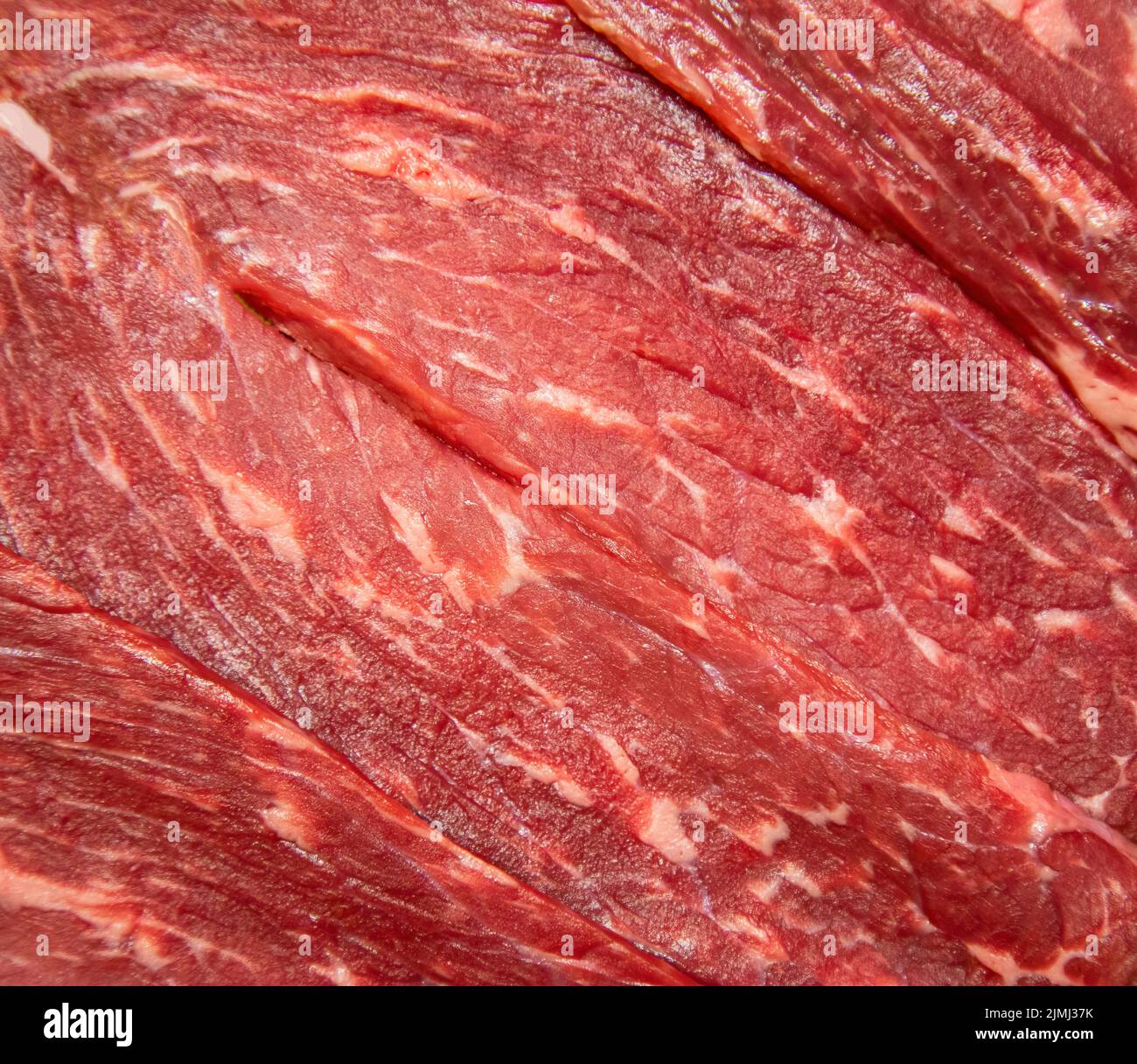 Fresh meat background. Raw uncooked red beef meat texture. Closeup