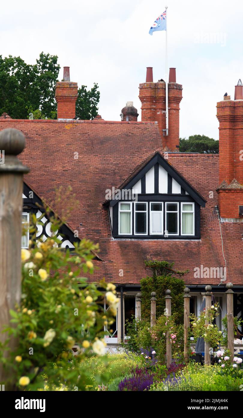 Petwood Hotel detail with RAF flag flying & climbing roses Stock Photo