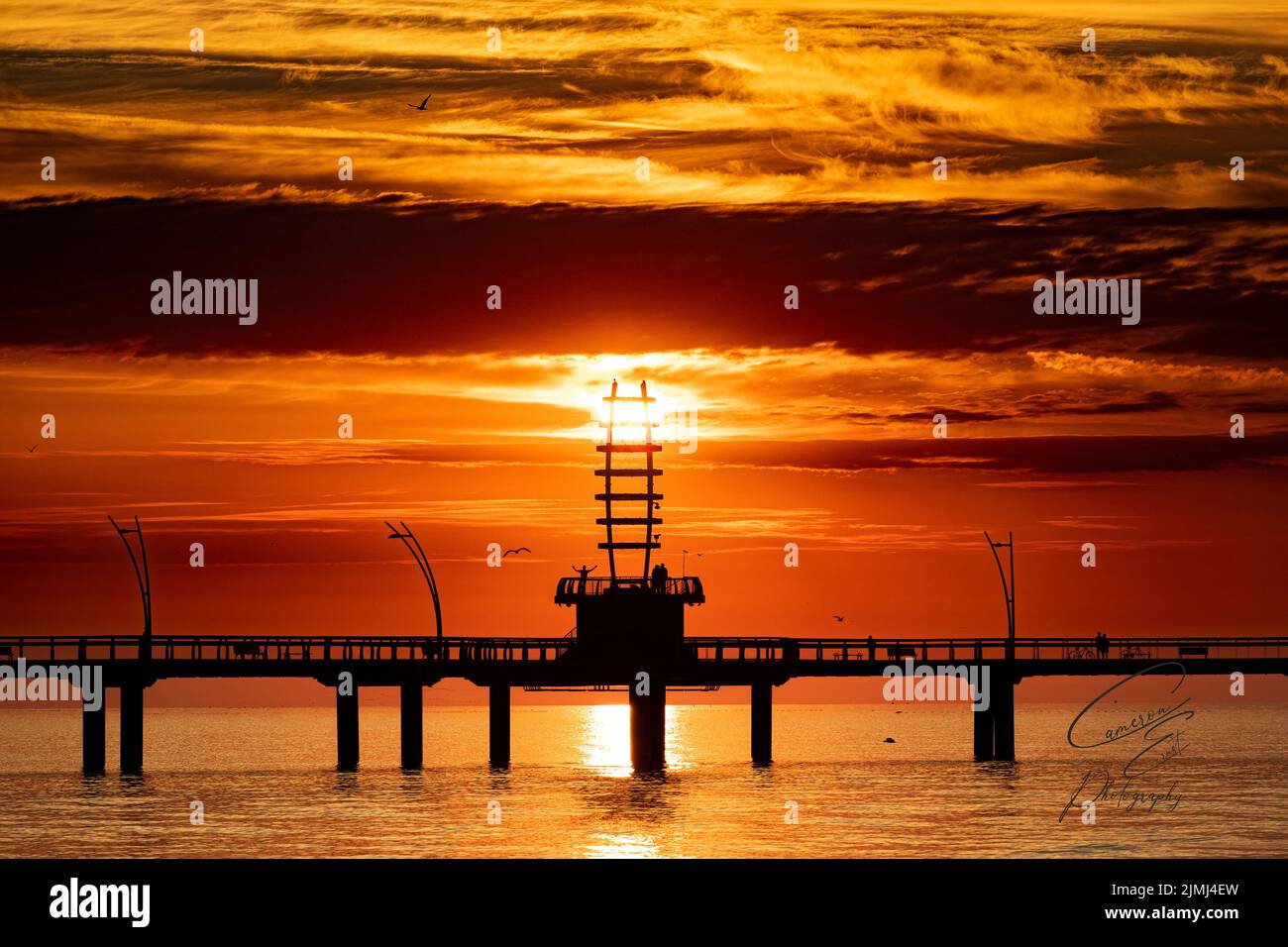 A silhouette of beacon made of tubular structural steel framing at sunset located in Brant Street Pier, Downtown Burlington Stock Photo