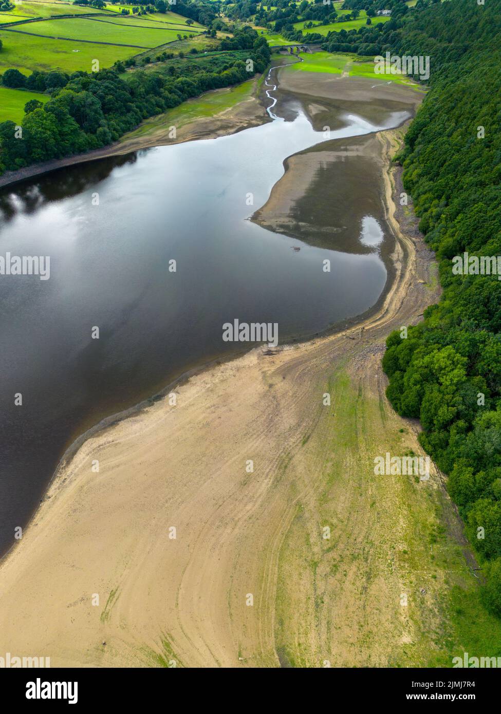 Aerial drone view of Lindley Wood Reservoir, North Yorkshire, showing the dry reservoir basin following heatwave & hot weather. Stock Photo