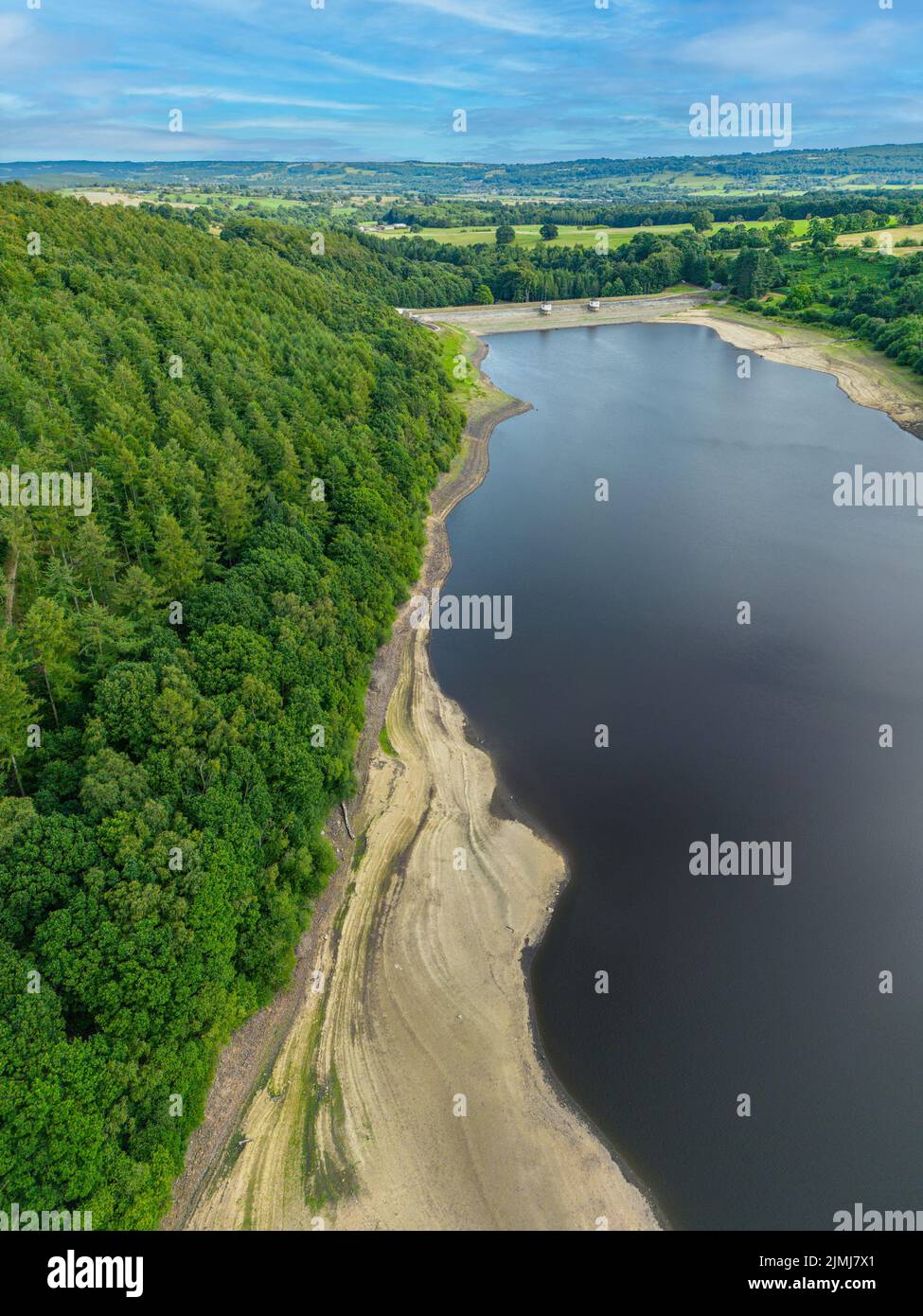 Aerial view of shrinking reservoir (Lindley Wood Reservoir) following