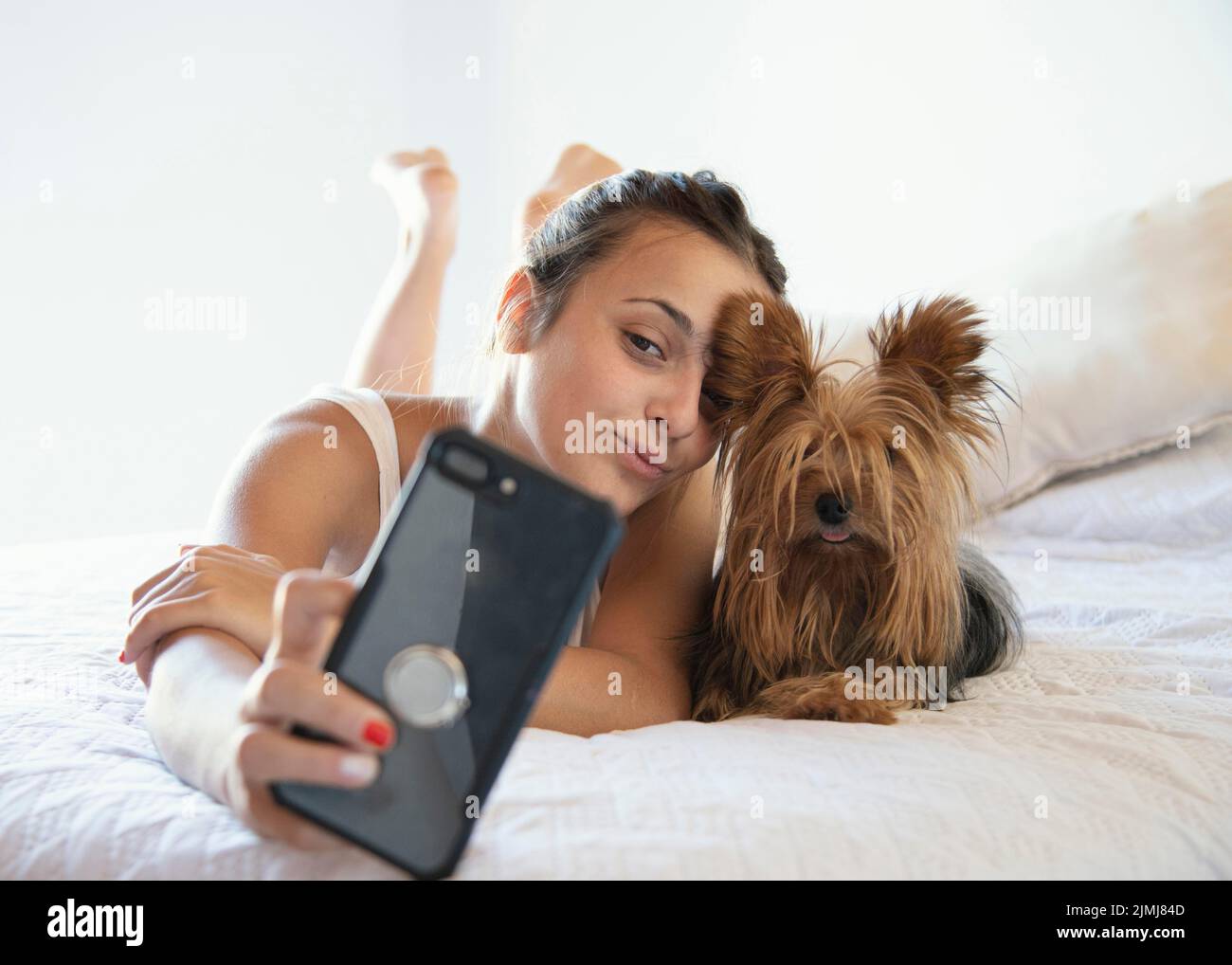 Young woman with dog taking selfie Stock Photo Alamy
