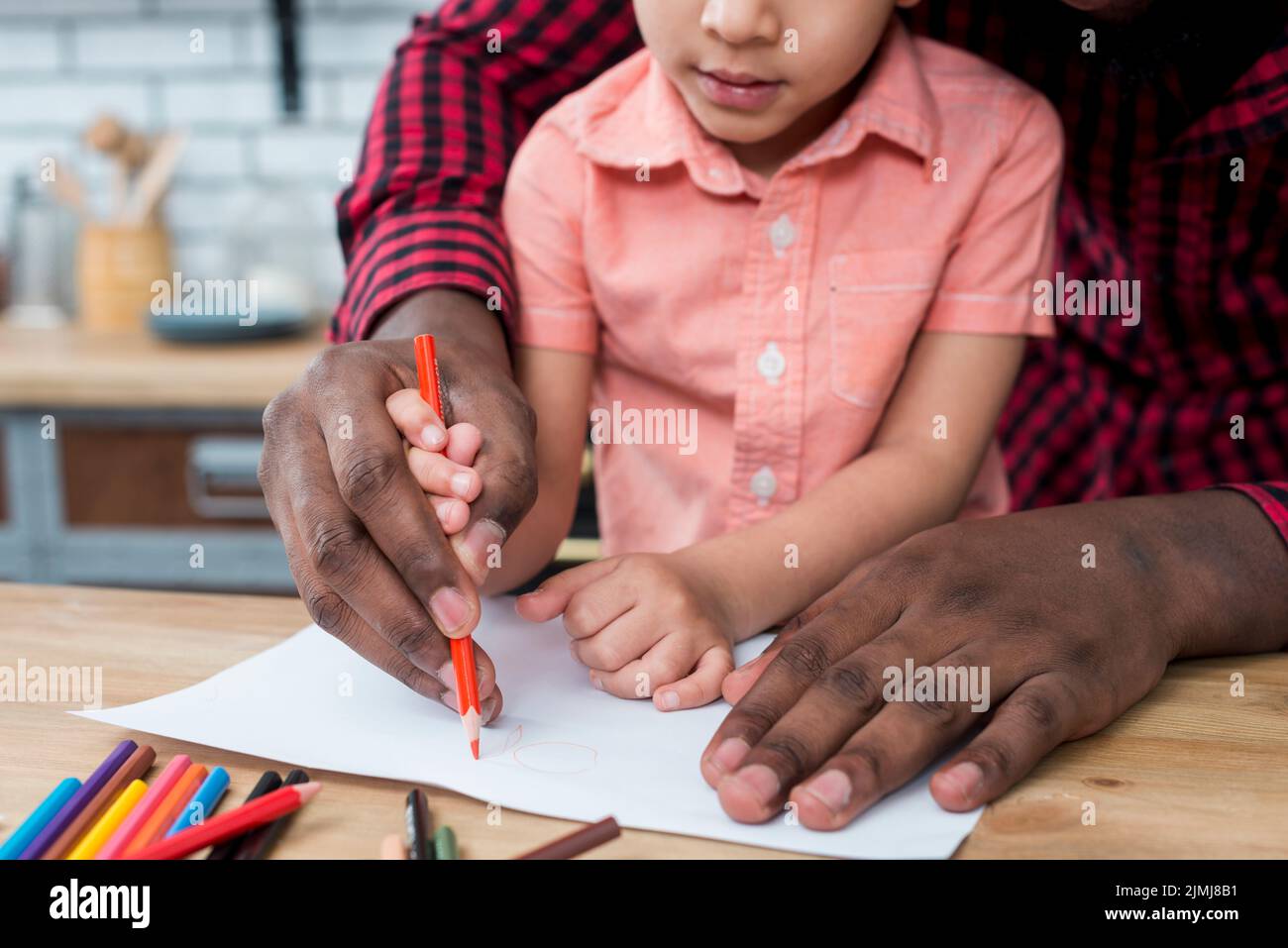 Black father son drawing paper Stock Photo