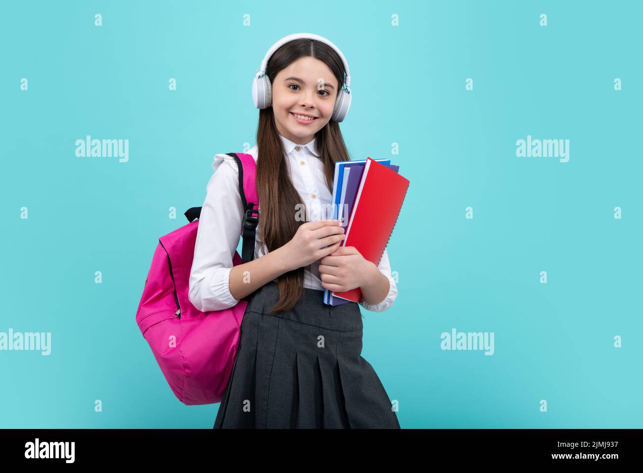 Back to school. Schoolgirl student in headphones with school bag ...