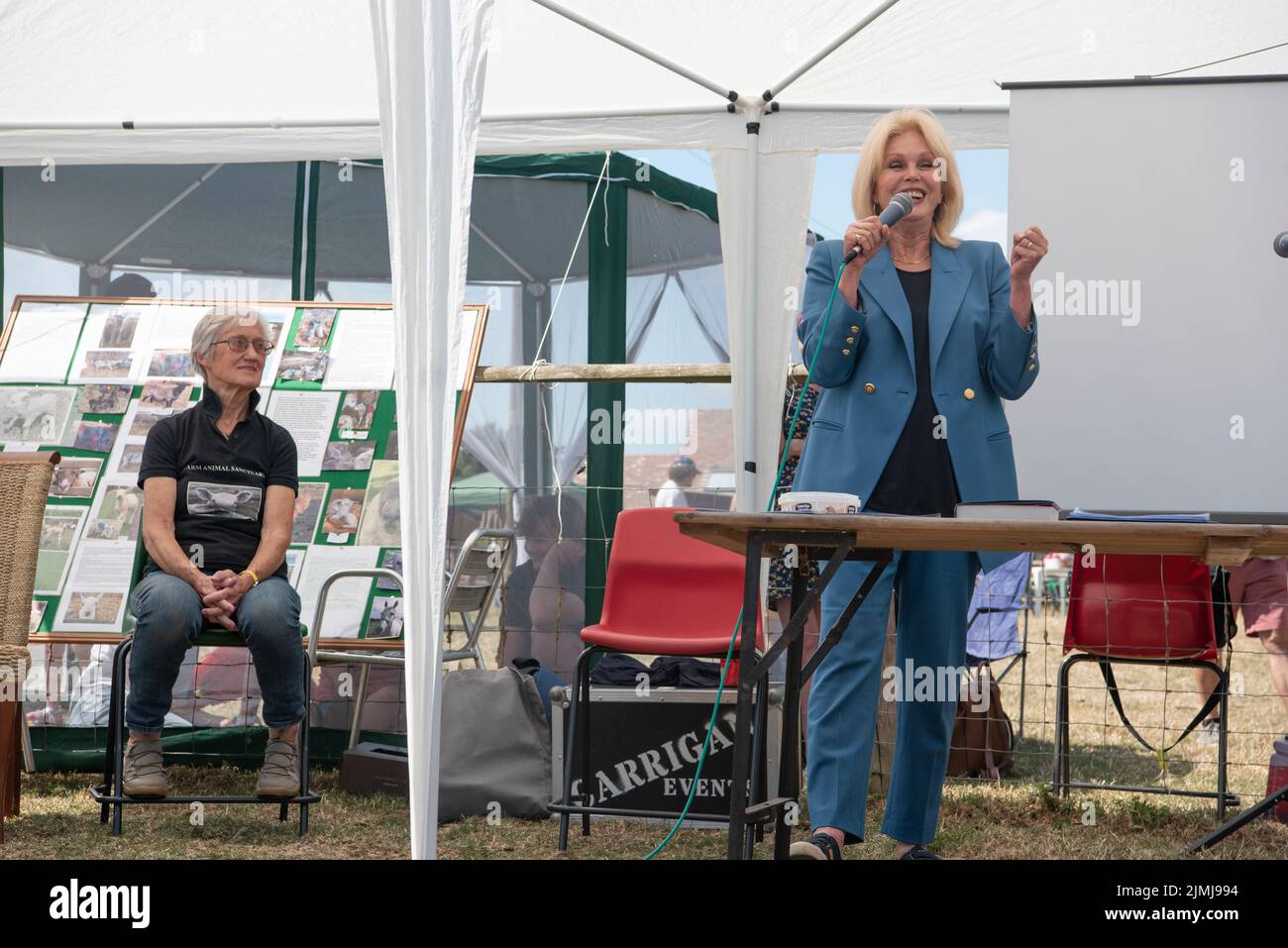 Dame Joanna Lumley OBE Speaking at The Farm Animal Sanctuary in Evesham on August 6th 2022. Vegetarian Joanna is a patron of The Farm Animal Sanctuary, which was Britain's first ever farm animal sanctuary. and is home to over 600 rescued farm animals. The Farm Animal Sanctuary owner Janet Taylor is sat on the left. Stock Photo