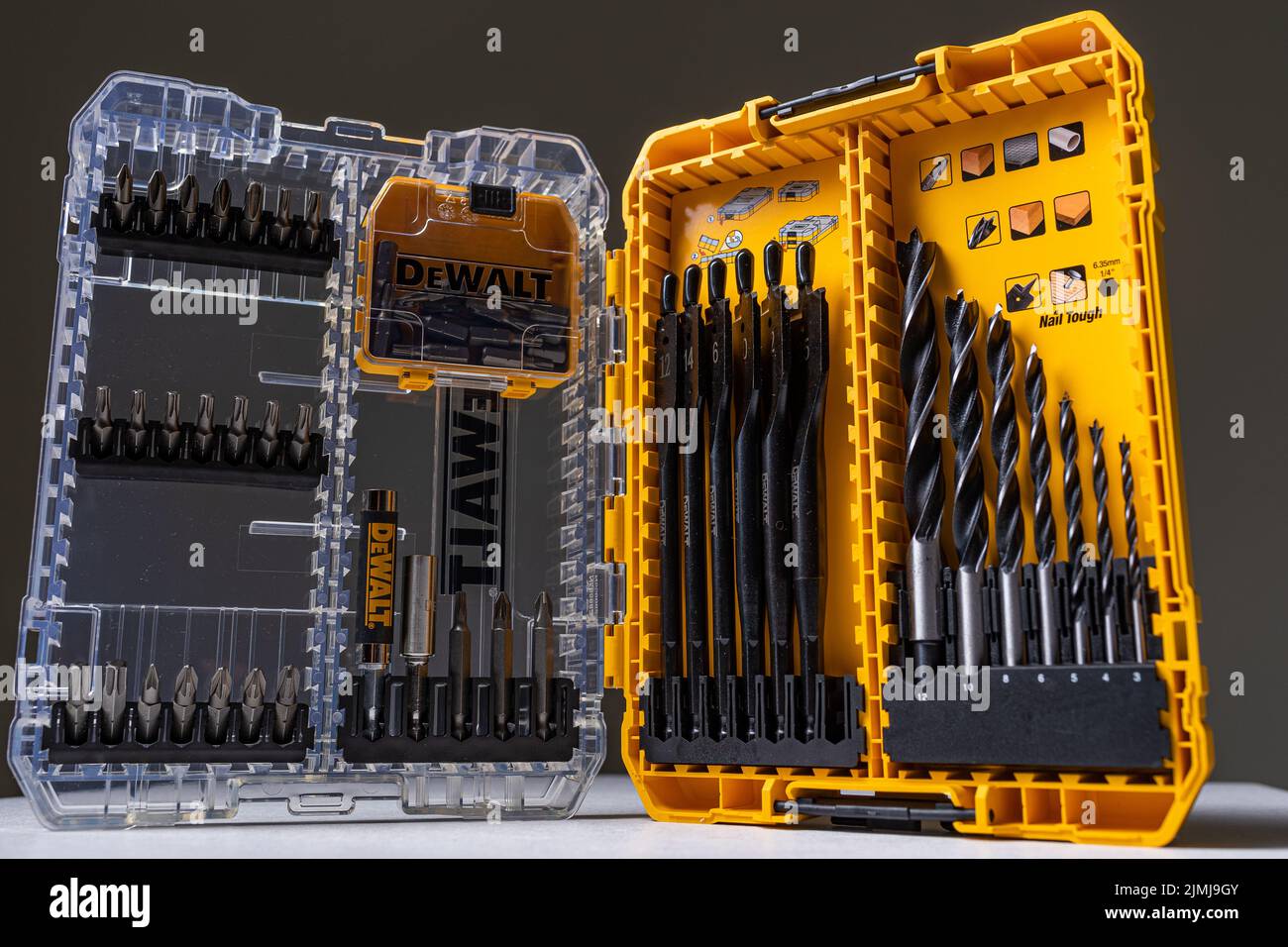 Photo shot of open yellow and transparent kit box with drills for