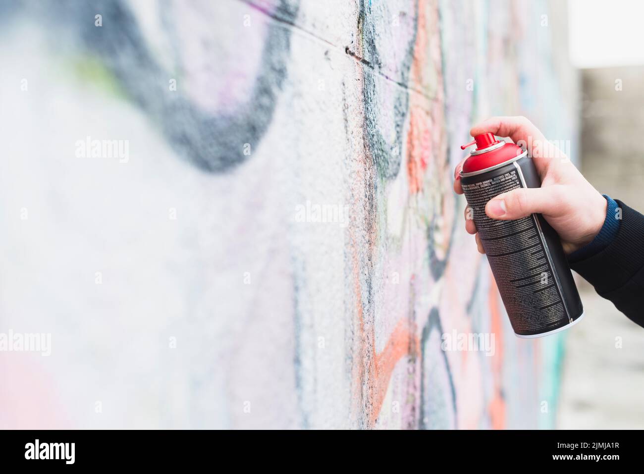 Artist painting graffiti with spray can Stock Photo - Alamy