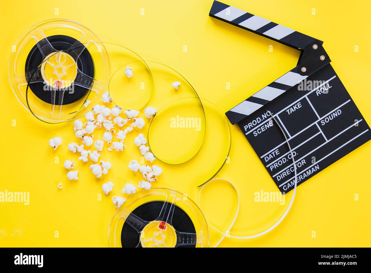 Composed clapboard with reels Stock Photo Alamy