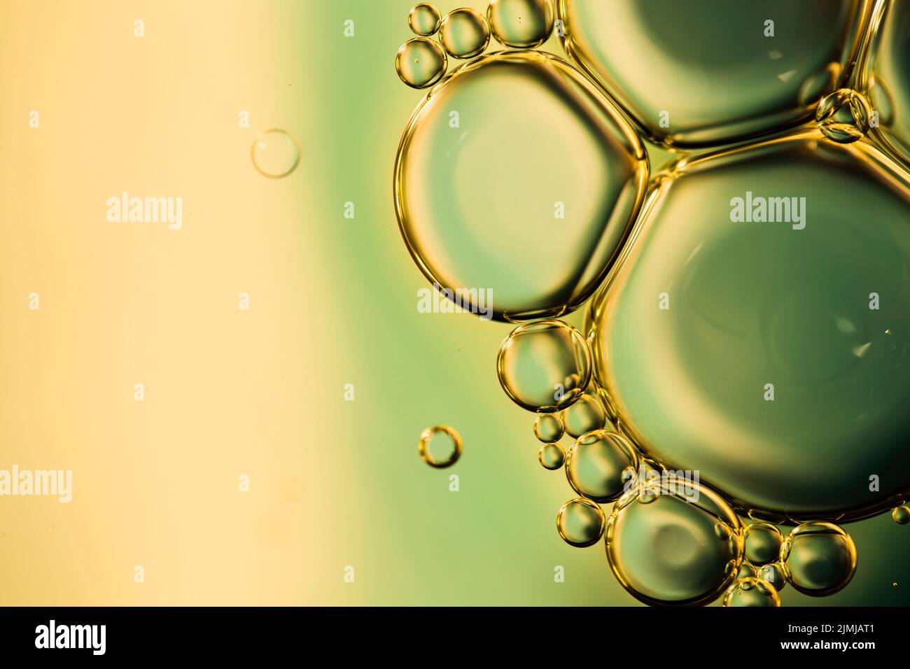 Close up oily bubbles droplets colourful watery backdrop Stock Photo