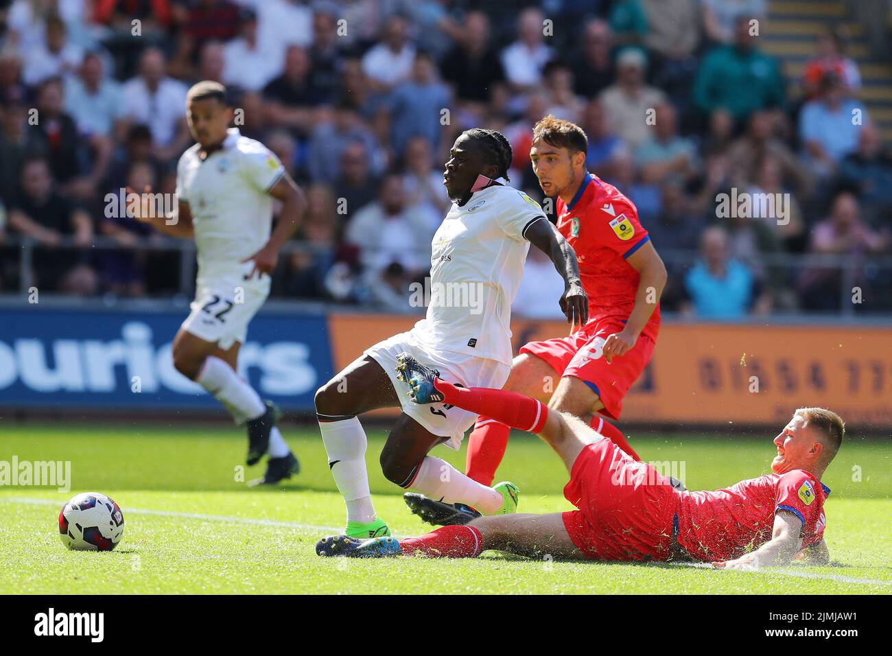 Swansea, UK. 06th Aug, 2022. Michael Obafemi of Swansea City is tackled by Scott Wharton of Blackburn Rovers (r). EFL Skybet championship match, Swansea city v Blackburn Rovers at the Swansea.com Stadium in Swansea, Wales on Saturday 6th August 2022. this image may only be used for Editorial purposes. Editorial use only, license required for commercial use. No use in betting, games or a single club/league/player publications. pic by Andrew Orchard/Andrew Orchard sports photography/Alamy Live news Credit: Andrew Orchard sports photography/Alamy Live News Stock Photo