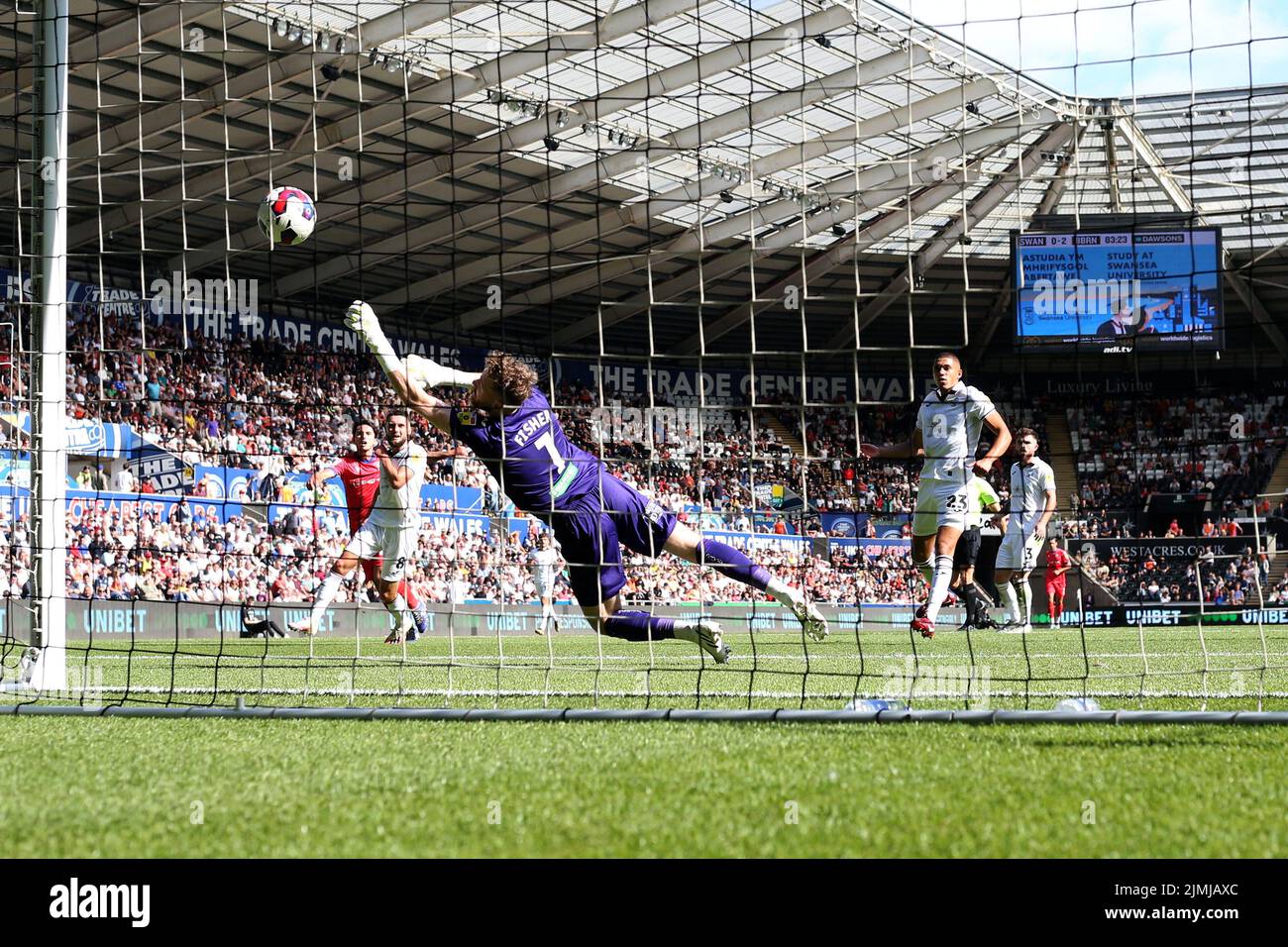 Swansea, UK. 06th Aug, 2022. Lewis Travis of Blackburn Rovers (l) beats Swansea city goalkeeper Andy Fisher as he shoots and scores his teams 3rd goal. EFL Skybet championship match, Swansea city v Blackburn Rovers at the Swansea.com Stadium in Swansea, Wales on Saturday 6th August 2022. this image may only be used for Editorial purposes. Editorial use only, license required for commercial use. No use in betting, games or a single club/league/player publications. pic by Andrew Orchard/Andrew Orchard sports photography/Alamy Live news Credit: Andrew Orchard sports photography/Alamy Live News Stock Photo