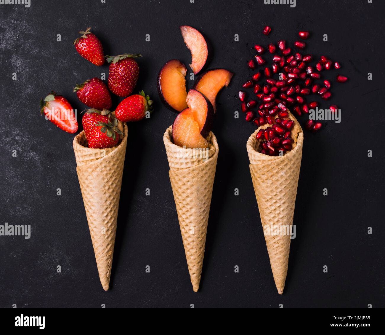 Ice cream cones with fruits Stock Photo