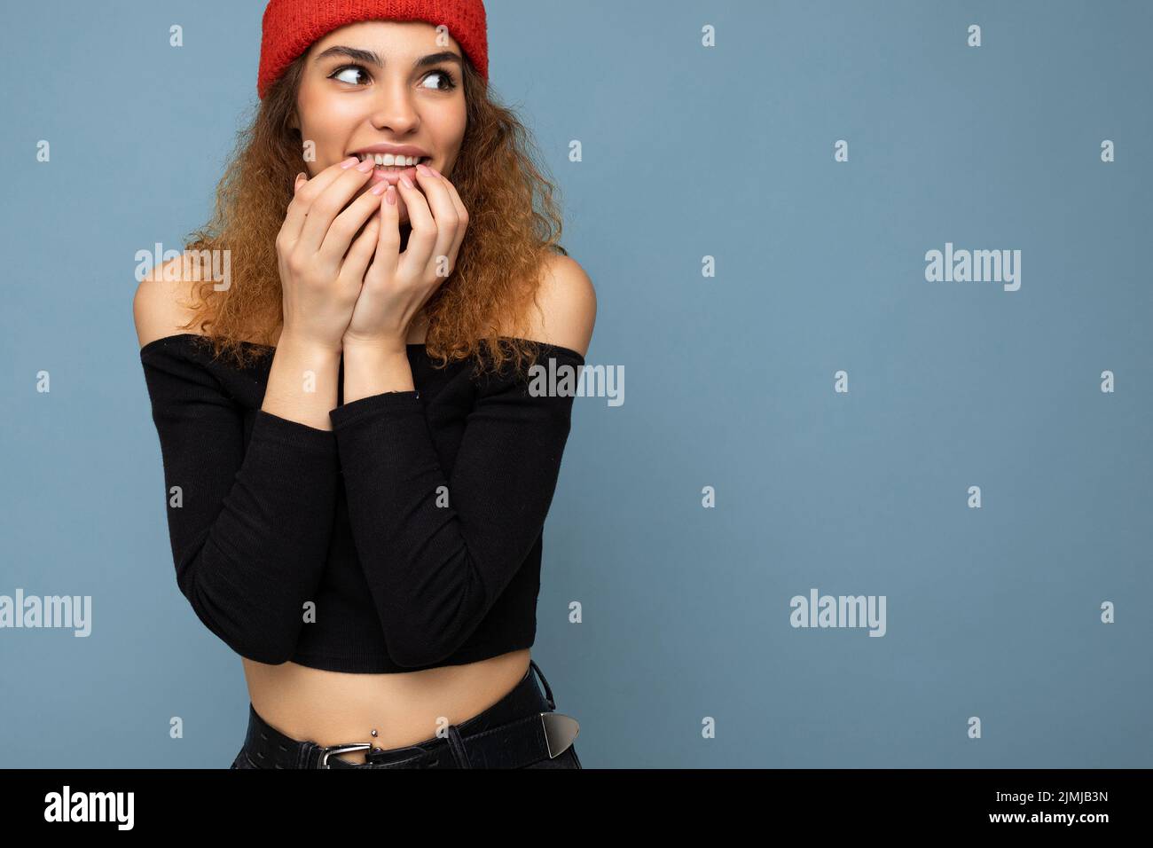 Shot of young emotional positive amazed surprised nice winsome brunet woman wavy-haired with sincere emotions wearing black crop Stock Photo