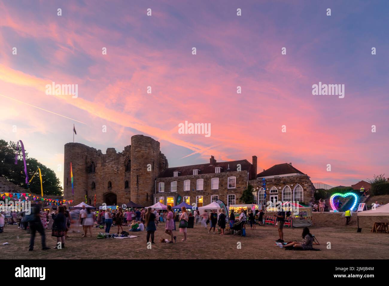 Tonbridge, Kent, England. 06 August 2022. The Tonbridge Pride inaugural event held on the lawn in front of Tonbridge Castle where all love is celebrated on a summers evening as the sun set over the castle ©Sarah Mott / Alamy Live News, Stock Photo
