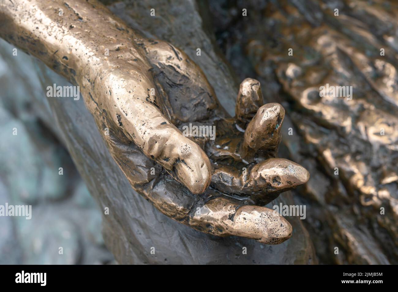 Metal hand open and ready to help or receive. Gesture hand hand of statue outstretched for salvation. Stock Photo
