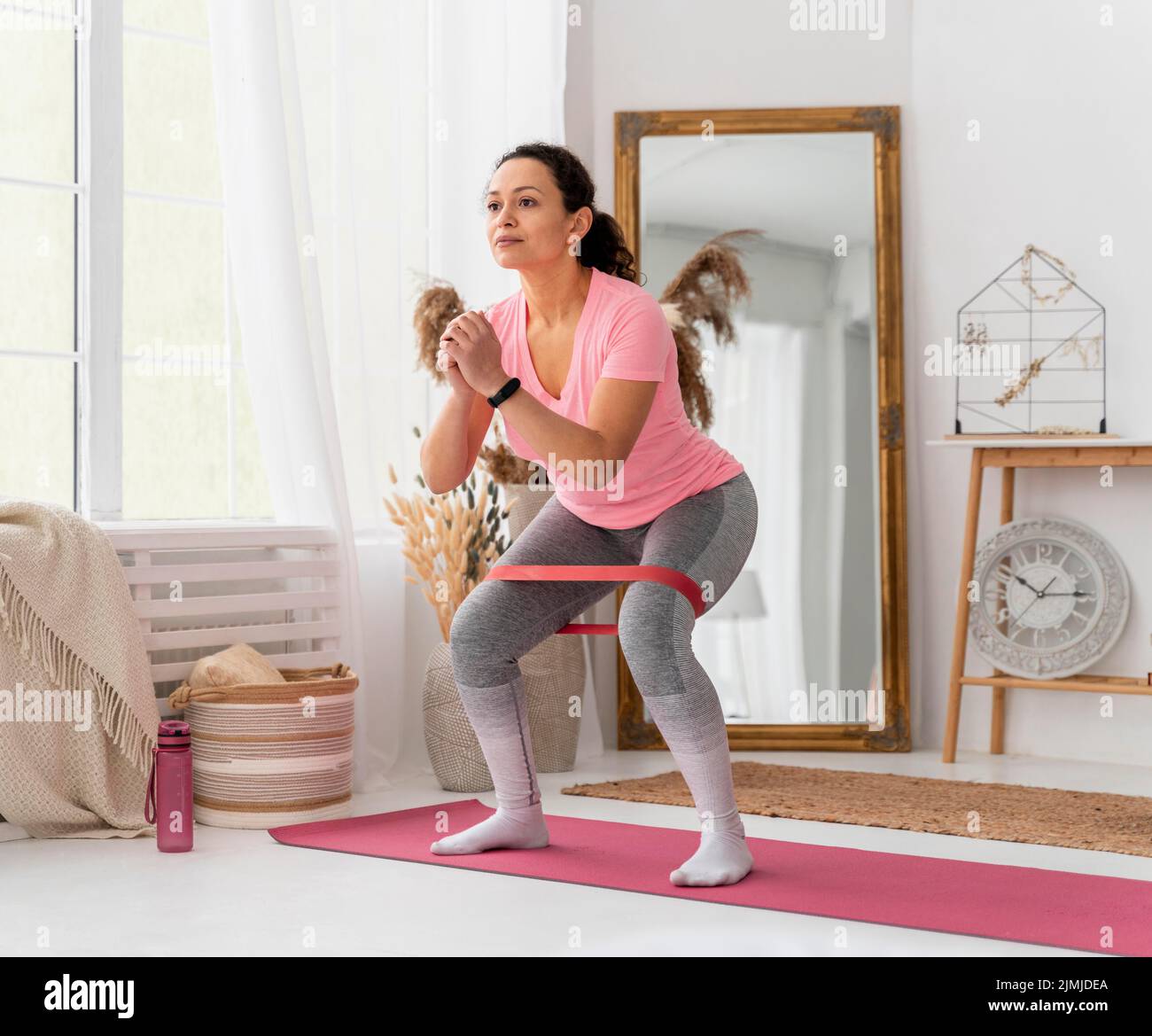 Full shot woman training with resistance band Stock Photo