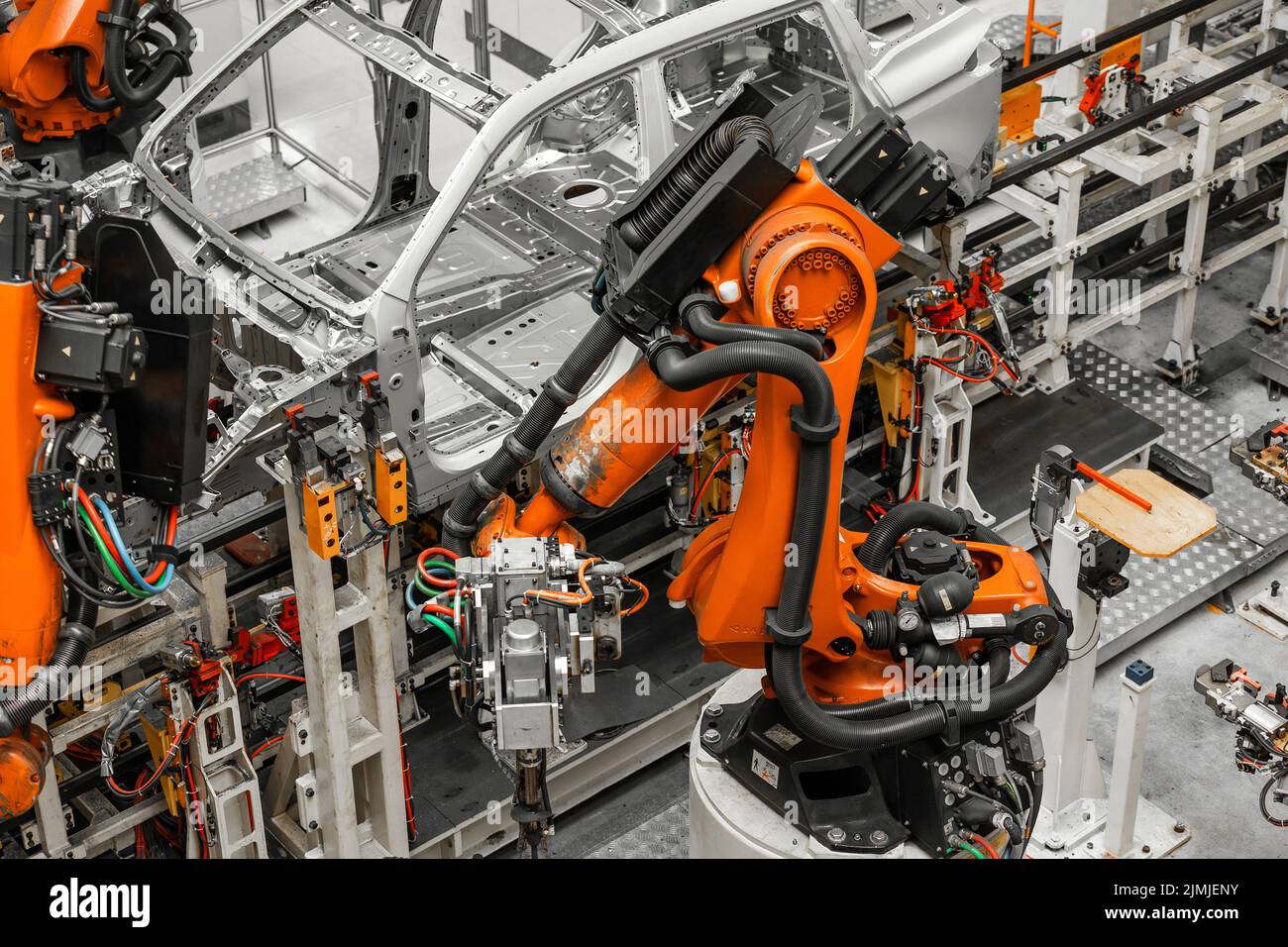 Car bodies are on assembly line. Factory for production of cars. Modern automotive industry. Electric car factory, conveyor Stock Photo