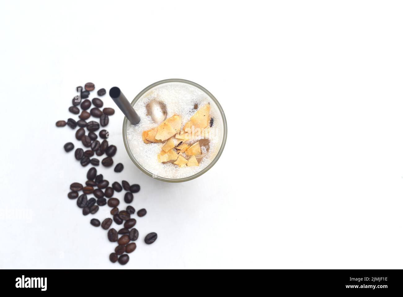 Coffee milk shake with burnt coconut and coffee beans isolated on white